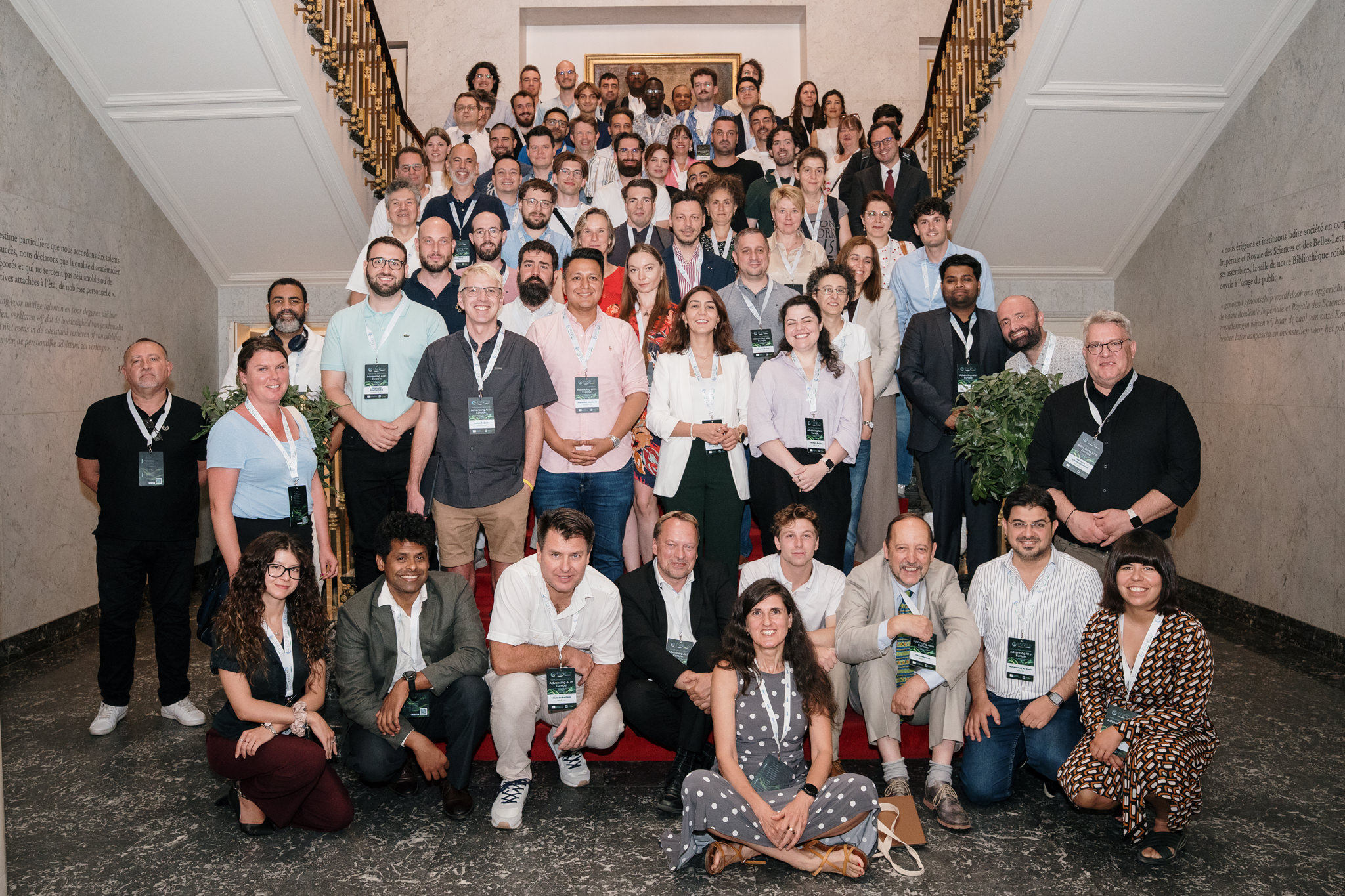 A group photo of attendees of the ENFIELD Final Conference, standing on a flight of stairs, smiling.